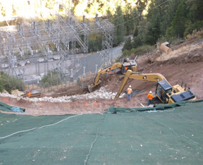 Construction site with excavators on a slope.