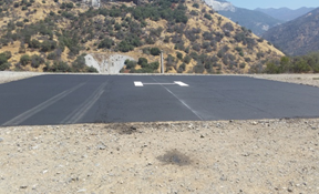 Helipad on mountain with surrounding landscape.